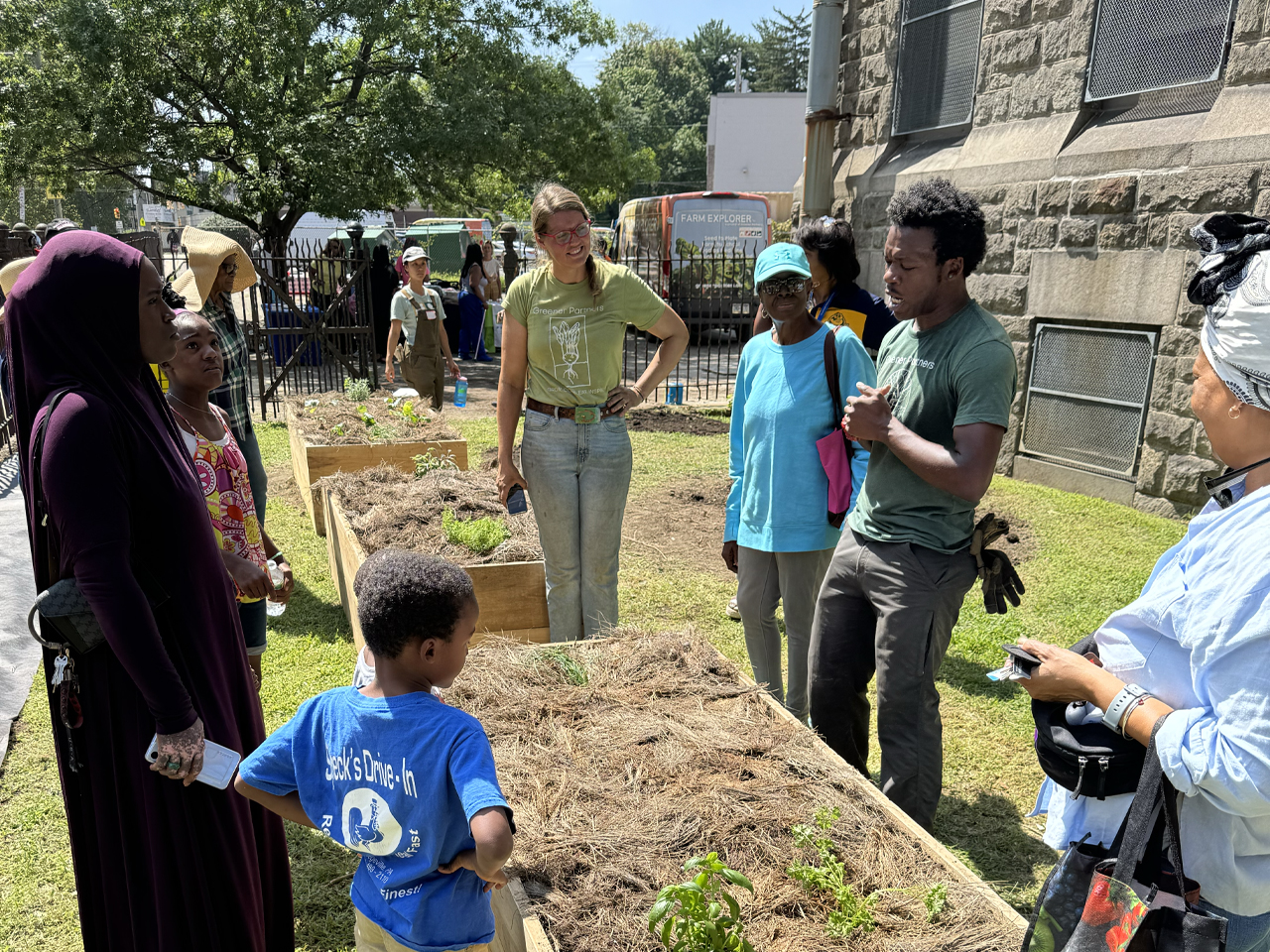 Students and community partners work together in the Overbrook Elementary School garden, learning about plants, sustainability, and environmental stewardship through hands-on activities.